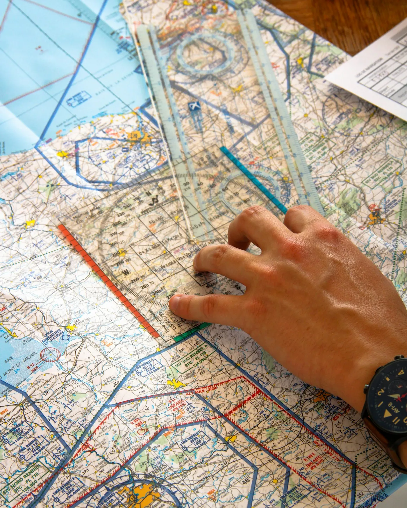 Mano trazando una ruta sobre una carta aeronáutica